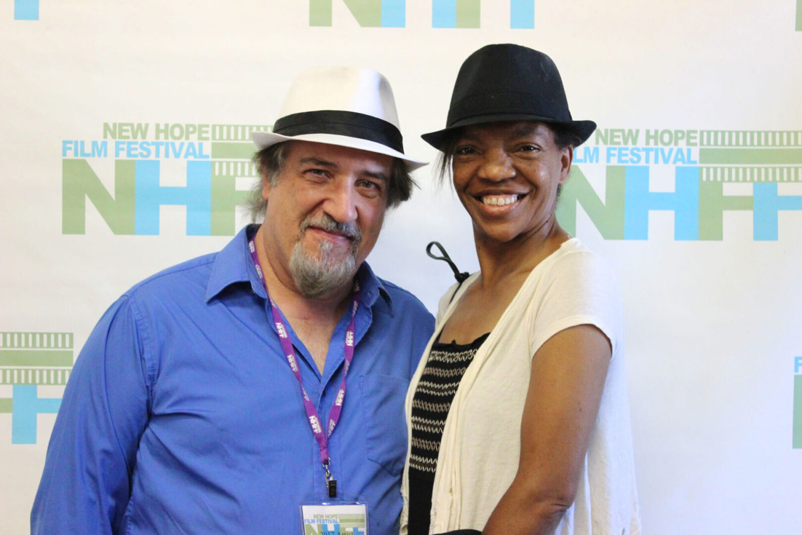 Two film festival attendees wearing formal hats